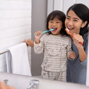 mom and child brushing teeth- top dental products for kids 
